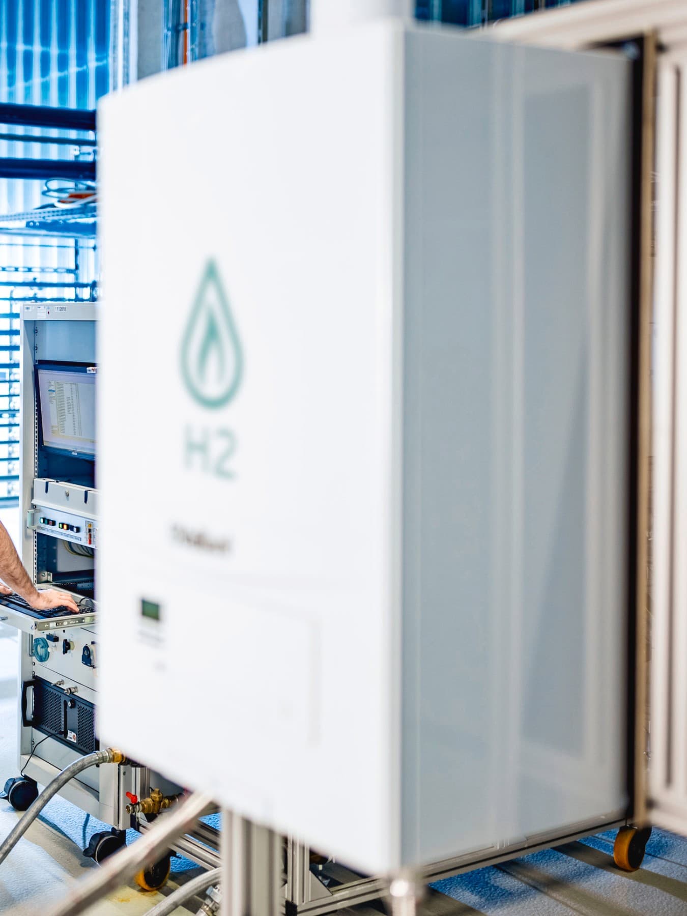 Installateur auf einem Prüfstand überprüft Daten aus einem Testlauf mit Wasserstoff