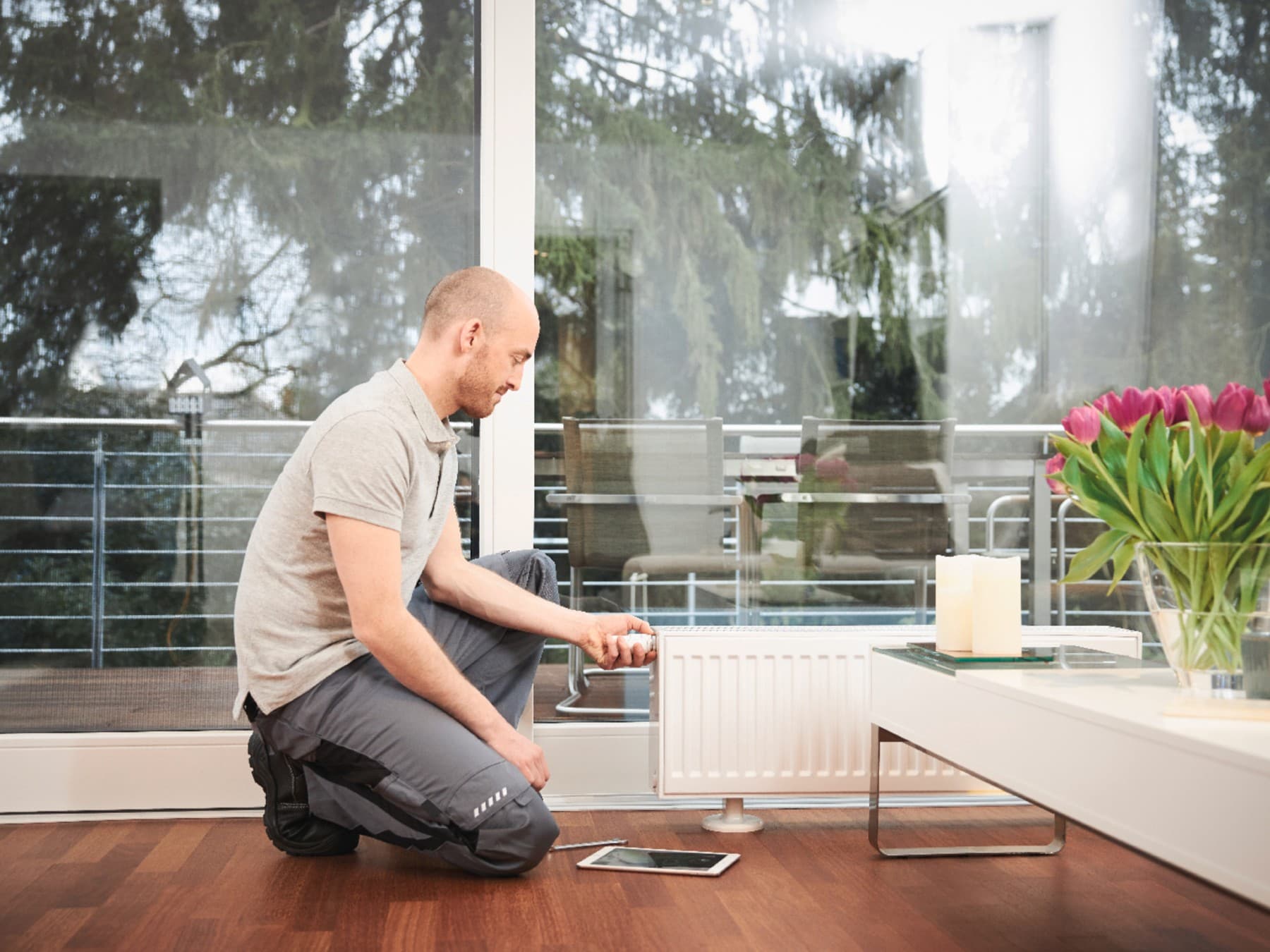 Professioneller Installateur beim Ausbalancieren eines Heizkörpers